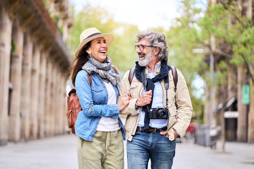 older couple smiling walking.