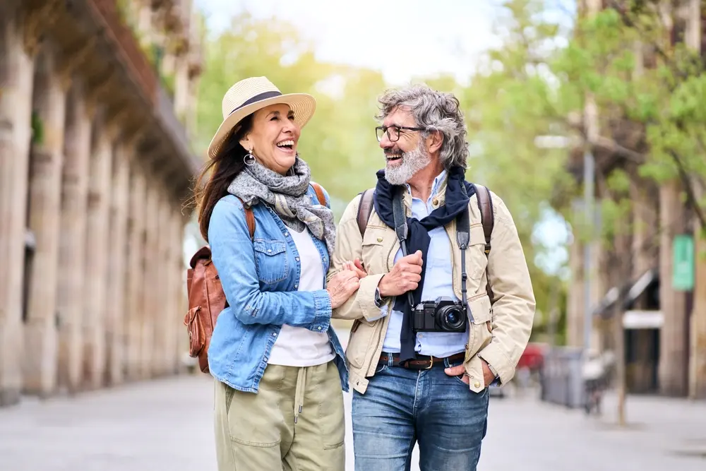 older couple smiling walking.